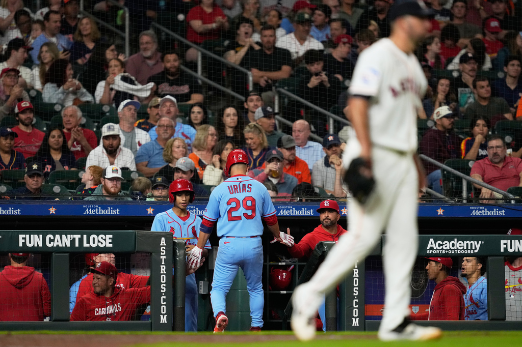 St. Louis Cardinals' Ramón Urías (29) returns to the dugout after scoring as Houston Astros pitcher Colton Gordon, right, returns to the mound during the seventh inning of a baseball game in Houston, Saturday, April 18, 2026. (AP Photo/Ashley Landis)
