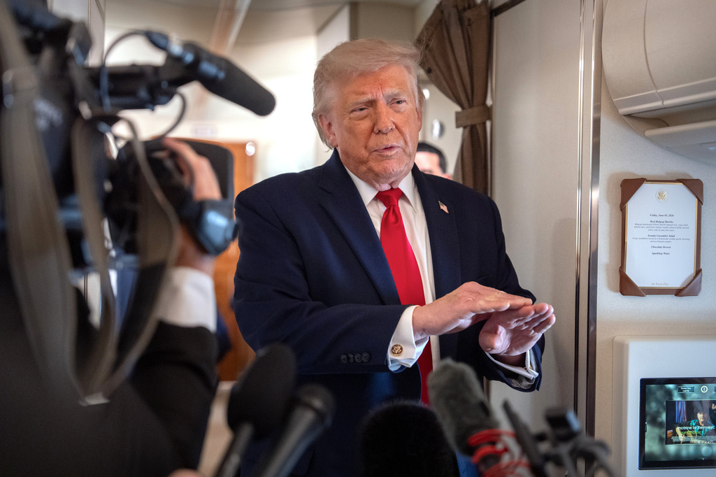 President Donald Trump speaks to reporters aboard Air Force One en route from Joint Base Andrews, Md., to Eau Claire, Wis., Friday, June 5, 2026. (AP Photo/Mark Schiefelbein)