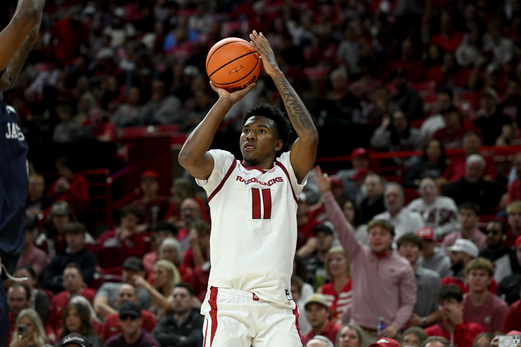 Arkansas guard Karter Knox (11) shoots a three point shot against Jackson State during the first half of an NCAA college basketball game Friday, Nov. 21, 2025, in Fayetteville, Ark. (AP Photo/Michael Woods)