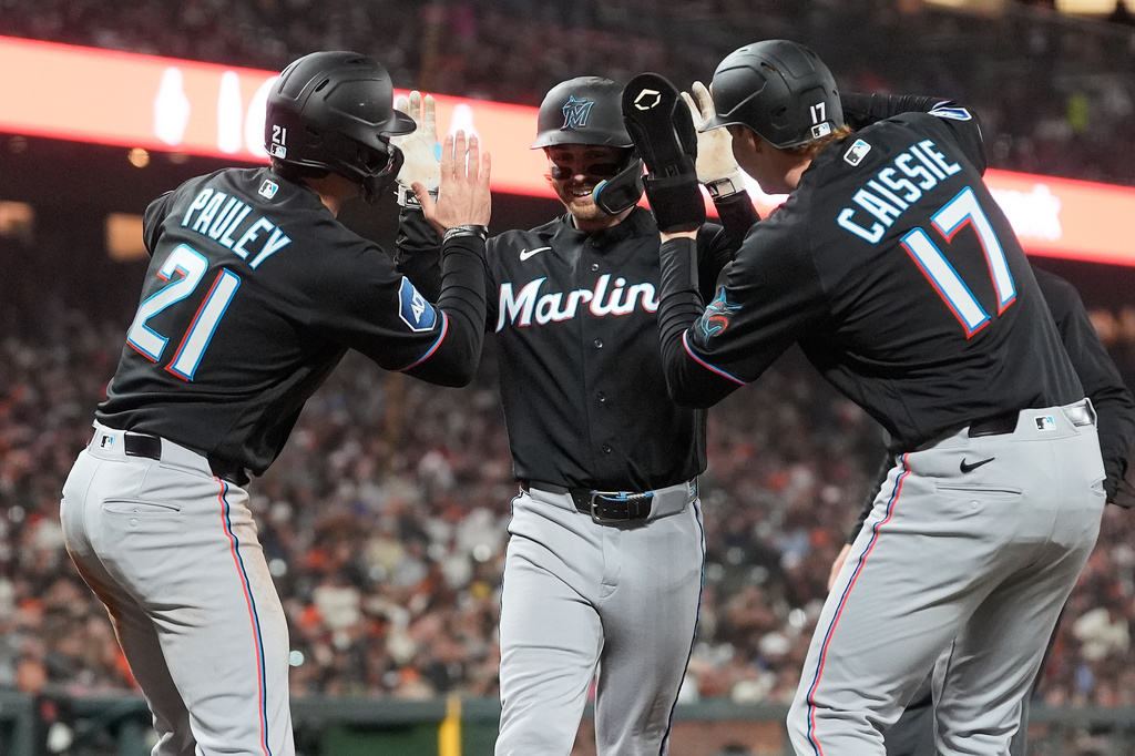 Miami Marlins' Connor Norby, middle, celebrates after hitting a three-run home run that also scored Graham Pauley (21) and Owen Caissie (17) during the fourth inning of a baseball game against the San Francisco Giants in San Francisco, Friday, April 24, 2026. (AP Photo/Jeff Chiu)