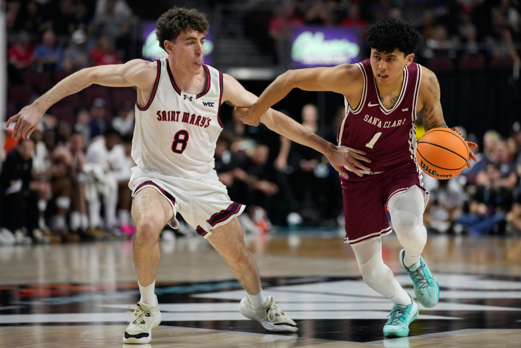 Santa Clara guard Christian Hammond (1) drives against Saint Mary's guard Rory Hawke (8) during the first half of an NCAA college basketball semifinal game in the West Coast Conference men's tournament Monday, March 9, 2026, in Las Vegas. (AP Photo/John Locher)