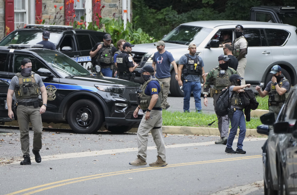 Officers from various federal agencies including Homeland Security Investigations, FBI, Department of Homeland Security from the Boston Field Office, and U.S. Park Police prepare for patrols at the U.S. Park Police Rock Creek Station, Thursday, Aug. 21, 2025, in Washington. (AP Photo/Jacquelyn Martin)