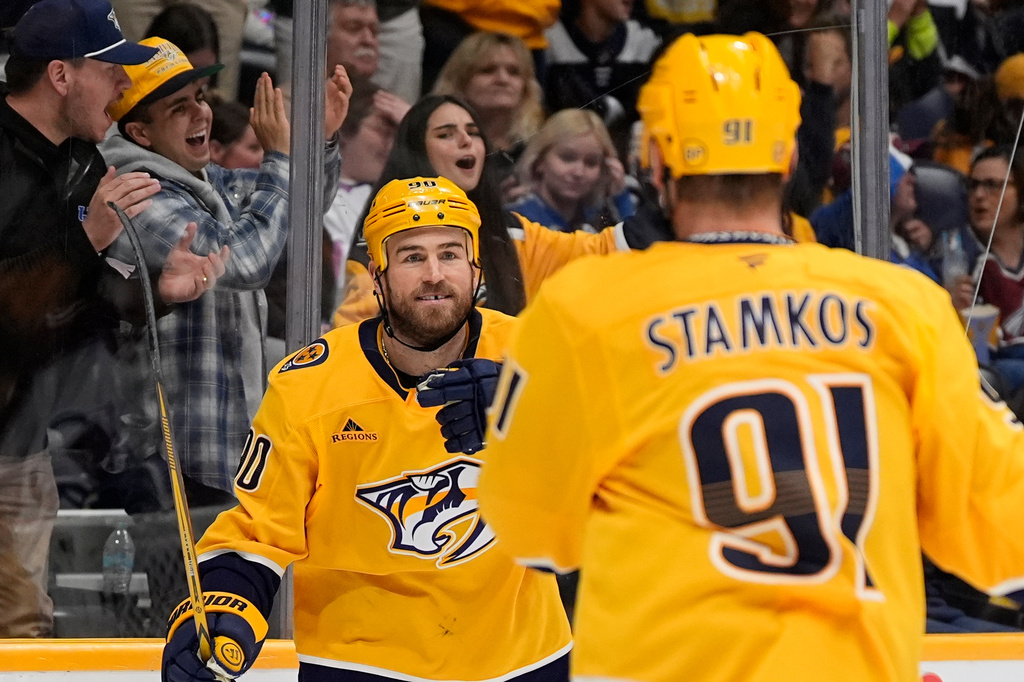 Nashville Predators center Ryan O'Reilly, left, celebrates his goal with Steven Stamkos (91) during the second period of an NHL hockey game Sunday, Oct. 25, 2026, in Nashville, Tenn. (AP Photo/George Walker IV)