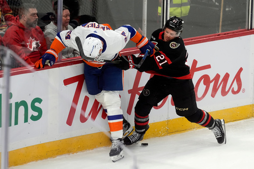 Ottawa Senators center Nick Cousins (21) gets his stick up on New York Islanders' Scott Mayfield (24) for a penalty during the first period of an NHL hockey game in Ottawa, Ontario, Saturday, Oct. 18, 2025. (Adrian Wyld/The Canadian Press via AP) Ottawa Senators center Nick Cousins (21) gets his stick up on New York Islanders' Scott Mayfield (24) for a penalty during the first period of an NHL hockey game in Ottawa, Ontario, Saturday, Oct. 18, 2025. (Adrian Wyld/The Canadian Press via AP)