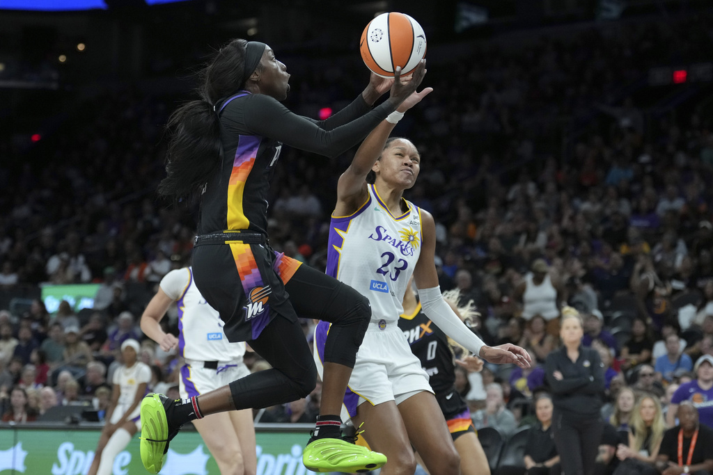 Phoenix Mercury guard Kahleah Copper, left, has her shot blocked by Los Angeles Sparks forward Azura Stevens (23) during the first half of a WNBA basketball game Tuesday, Sept. 9, 2025, in Phoenix. (AP Photo/Ross D. Franklin)