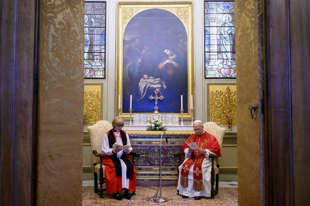 Pope Leo XIV prays with the Archbishop of Canterbury, Sarah Mullally, left, in the Urban VIII Chapel inside the Apostolic Palace, at the Vatican, Monday, April 27, 2026. (Vatican Media via AP)