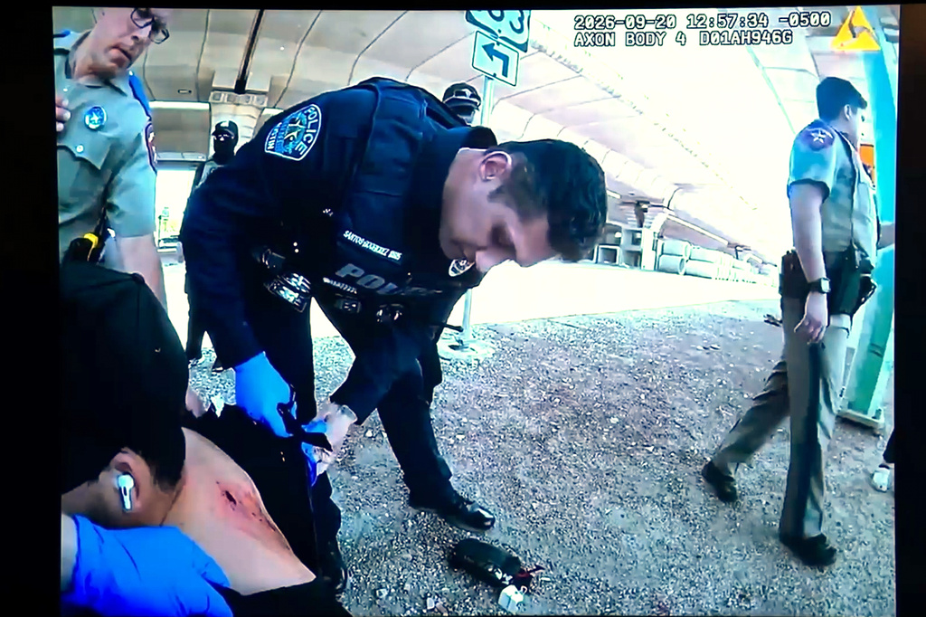 In this image taken from an Austin Police Department officer's body camera video shown at a news conference on Tuesday, Sept. 22, 2026, officers inspect Wilber Rafael Garces Perez's wound after he was shot by a U.S. Immigration and Customs Enforcement agent Sunday, Sept. 20 in Austin. (Austin Police Department via AP)