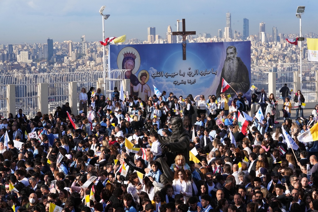 People wait for the arrival of Pope Leo XIV to visit the De la Croix hospital in Jal el Dib, Lebanon, Tuesday, Dec. 2, 2025. (AP Photo/Domenico Stinellis)