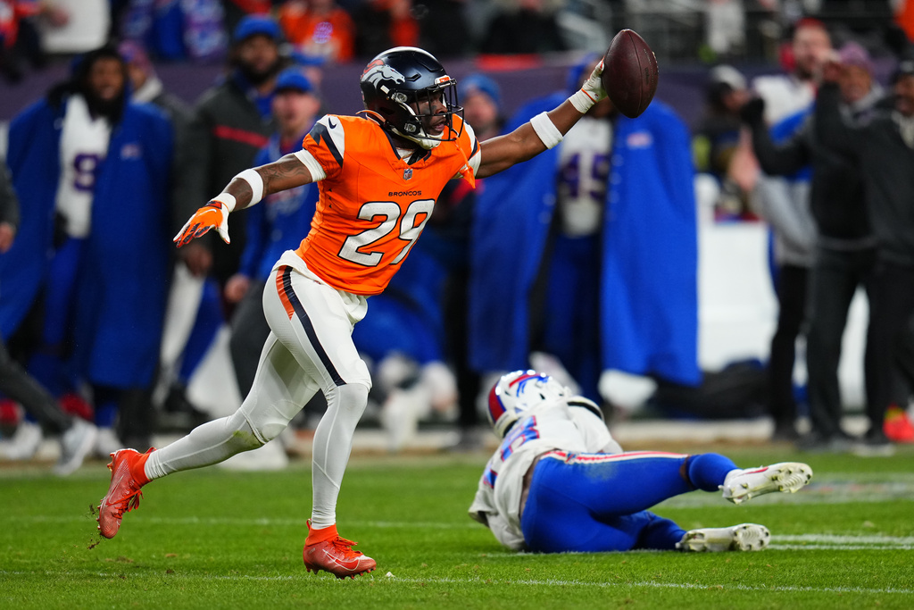 Denver Broncos cornerback Ja'quan McMillian (29) reacts after intercepting a pass intended for Buffalo Bills wide receiver Brandin Cooks (18) during overtime of an NFL divisional round playoff football game, Saturday, Jan. 17, 2026, in Denver. (AP Photo/Jack Dempsey)