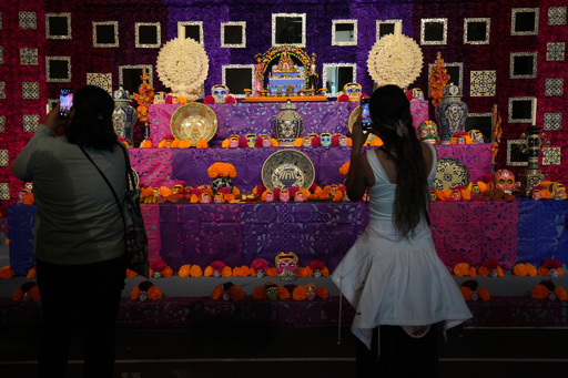 Visitors photograph a Day of the Dead altar adorned with sugar skulls known as “calaveritas” or little skulls, at the Casa de Mujeres Artesanas Indígenas in downtown Mexico City, Friday, Oct. 31, 2025. (AP Photo/Claudia Rosel) Visitors photograph a Day of the Dead altar adorned with sugar skulls known as “calaveritas” or little skulls, at the Casa de Mujeres Artesanas Indígenas in downtown Mexico City, Friday, Oct. 31, 2025. (AP Photo/Claudia Rosel)