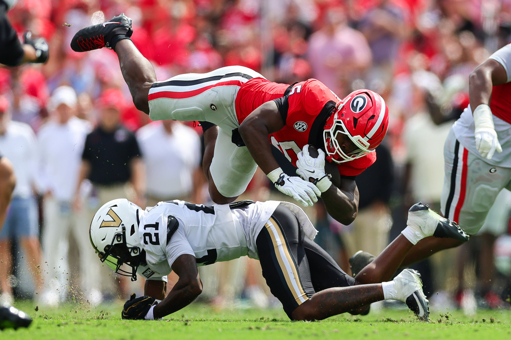 Vanderbilt safety Davin Chandler (21) tackles Georgia running back Chauncey Bowens (5) during the first half of an NCAA college football game, Saturday, Oct. 3, 2026, in Athens, Ga. (AP Photo/Colin Hubbard)