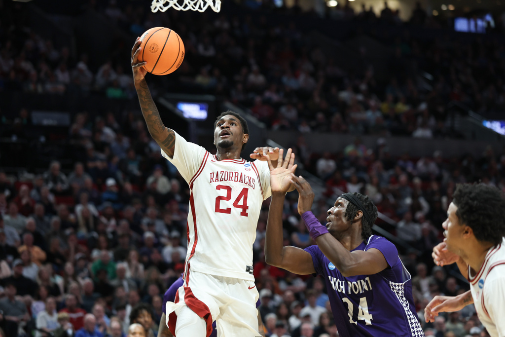 Arkansas forward Billy Richmond III (24) shoots as High Point center Youssouf Singare (24) defends during the first half in the second round of the NCAA college basketball tournament Saturday, March 21, 2026, in Portland, Ore. (AP Photo/Craig Mitchelldyer)