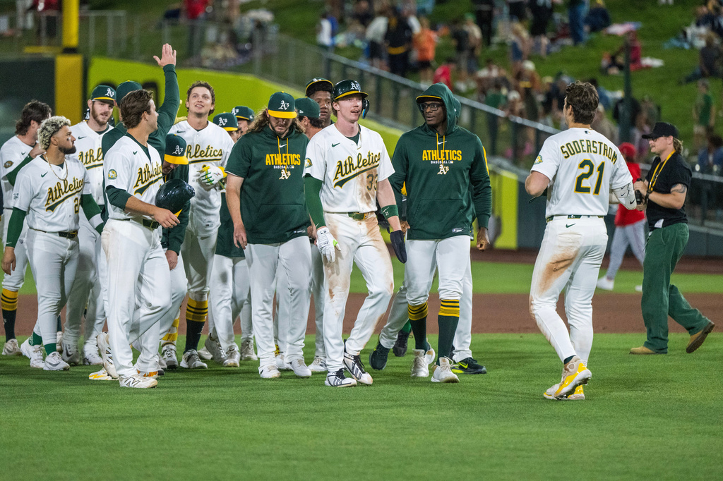 The Athletics celebrate winning a baseball game against the Los Angeles Angels in West Sacramento, Calif., Friday, June 19, 2026. (AP Photo/Nic Coury)