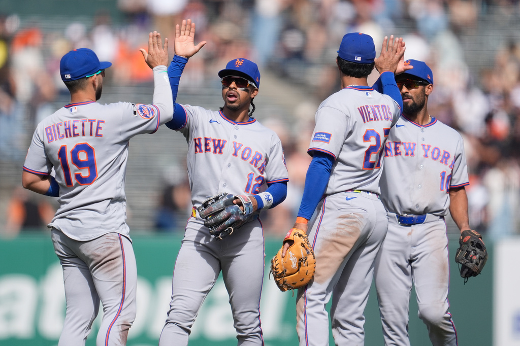 New York Mets' Bo Bichette, from left, celebrates with Francisco Lindor, Mark Vientos and Marcus Semien after a baseball game against the San Francisco Giants in San Francisco, Sunday, April 5, 2026. (AP Photo/Jeff Chiu)