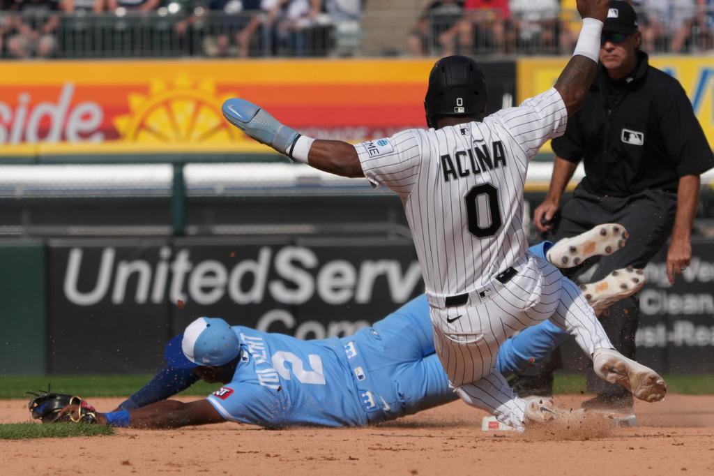 Chicago White Sox' Luisangel Acuña (0) is safe at second base as Kansas City Royals second baseman Tyler Tolbert (2) can't handle an errant throw during the seventh inning of a baseball game Saturday, June 27, 2026, in Chicago. (AP Photo/David Banks)