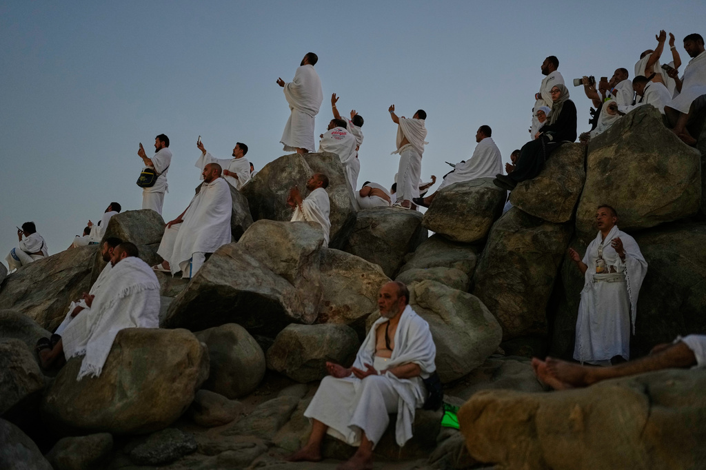 Muslim pilgrims pray at top of the rocky hill known as the Mountain of Mercy, on the Plain of Arafat, during the annual Hajj pilgrimage near the holy city of Mecca, Saudi Arabia, Tuesday, May 26, 2026. (AP Photo/Altaf Qadri)