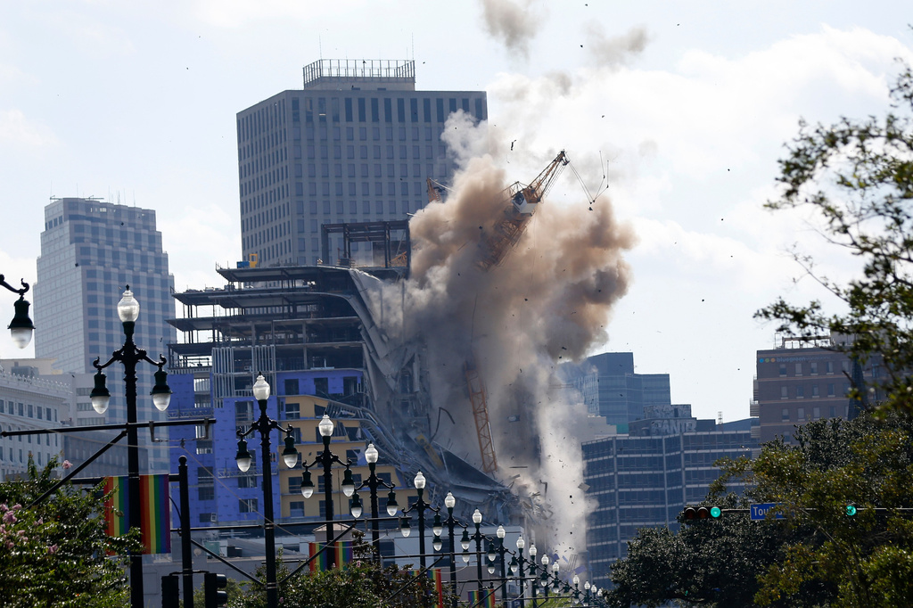 FILE - Two large cranes from construction at the Hard Rock Hotel come crashing down after being detonated for implosion in New Orleans, Oct. 20, 2019. (AP Photo/Gerald Herbert, File)
