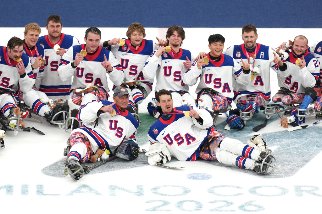 United States' players celebrate after winning the gold medal at the ice hockey final match between United States and Canada at the 2026 Winter Paralympics, in Milan, Italy, Sunday, March 15, 2026. (AP Photo/Antonio Calanni)