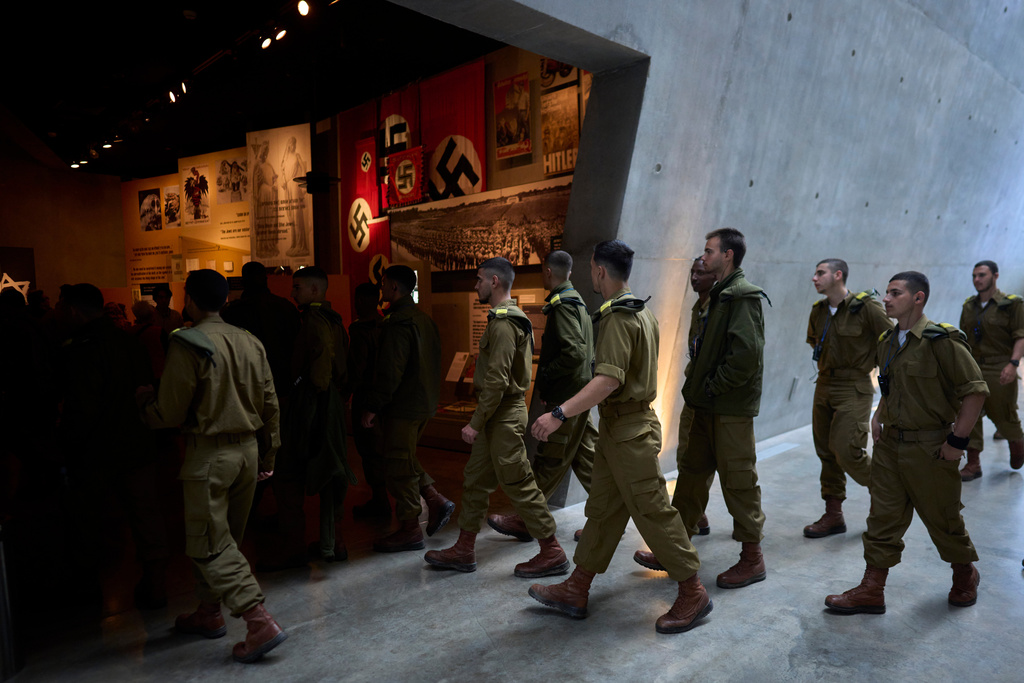 A group of Israeli soldiers looks at exhibits at the Yad Vashem Holocaust memorial in Jerusalem, ahead of the International Holocaust Remembrance Day, Sunday, Jan. 25, 2026. (AP Photo/Ohad Zwigenberg)