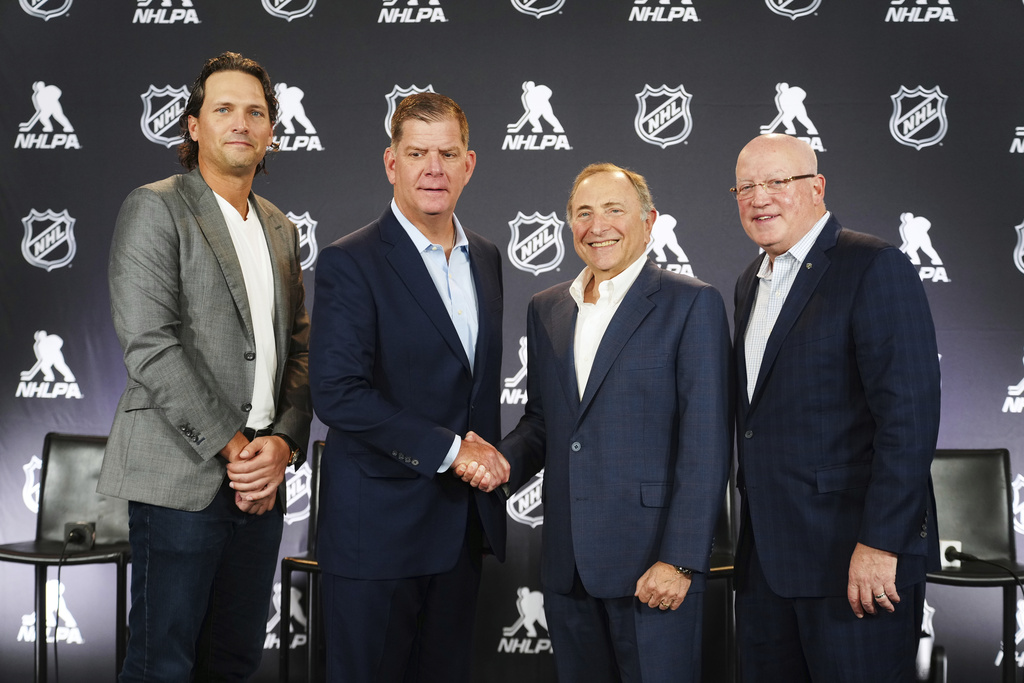 FILE - From left to right, Ron Hainsey, NHLPA Assistant Executive Director, Marty Walsh, NHLPA Executive Director, Gary Bettman, NHL Commissioner, and Bill Daly, NHL Deputy Commissioner, pose for photos after a joint press conference before the NHL hockey draft, June 27, 2025, in Los Angeles. (AP Photo/Damian Dovarganes, file)