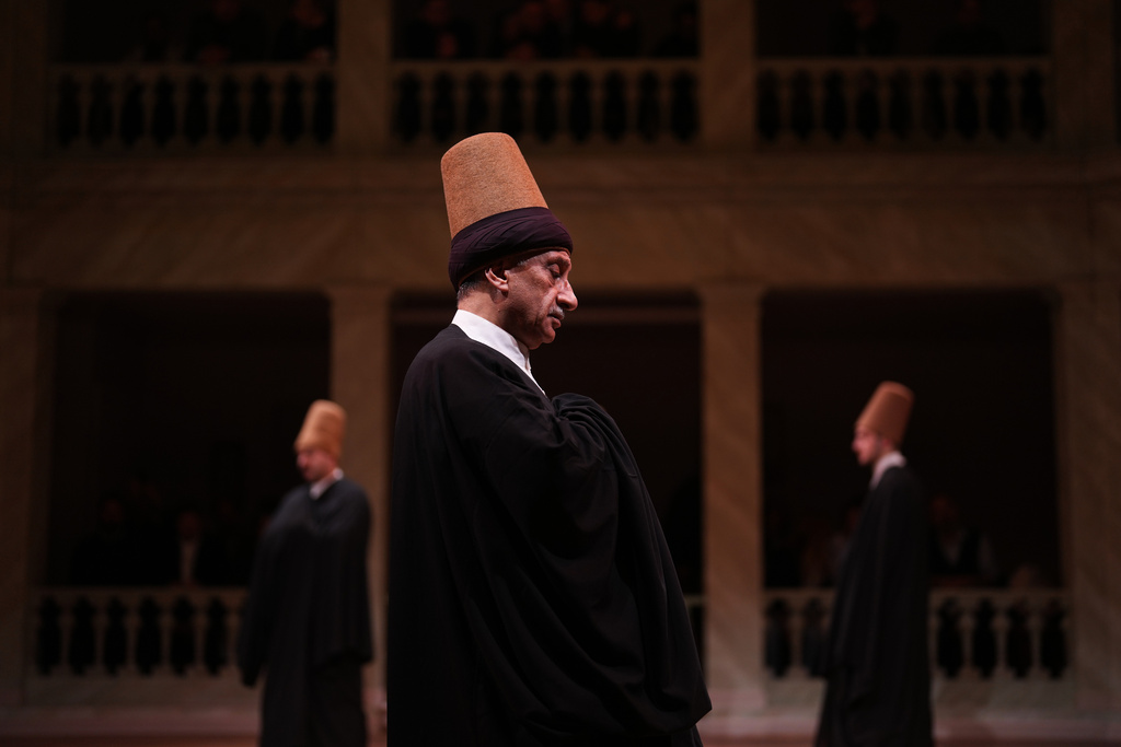 Whirling dervishes of the Mevlevi order perform during a Sheb-i Arus ceremony at Kasimpasa Mevlevihane in Istanbul, Turkey, Thursday, Dec. 11, 2025, to commemorate the death of 13th century Islamic scholar, poet and Sufi mystic Jalaladdin Rumi. (AP Photo/Francisco Seco)