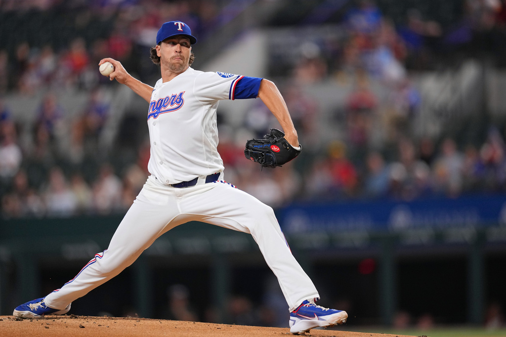 Texas Rangers starting pitcher Jacob deGrom throws to the Los Angeles Angels during the first inning of a baseball game, Tuesday, July 7, 2026, in Arlington, Texas. (AP Photo/Julio Cortez)