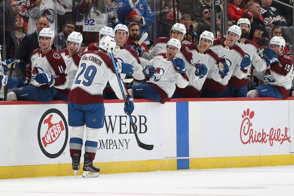 Colorado Avalanche's Nathan MacKinnon reacts with teammates after scoring during the first period of an NHL hockey game against the New Jersey Devils Sunday, Oct. 26, 2025, in Newark, N.J. (AP Photo/Pamela Smith)