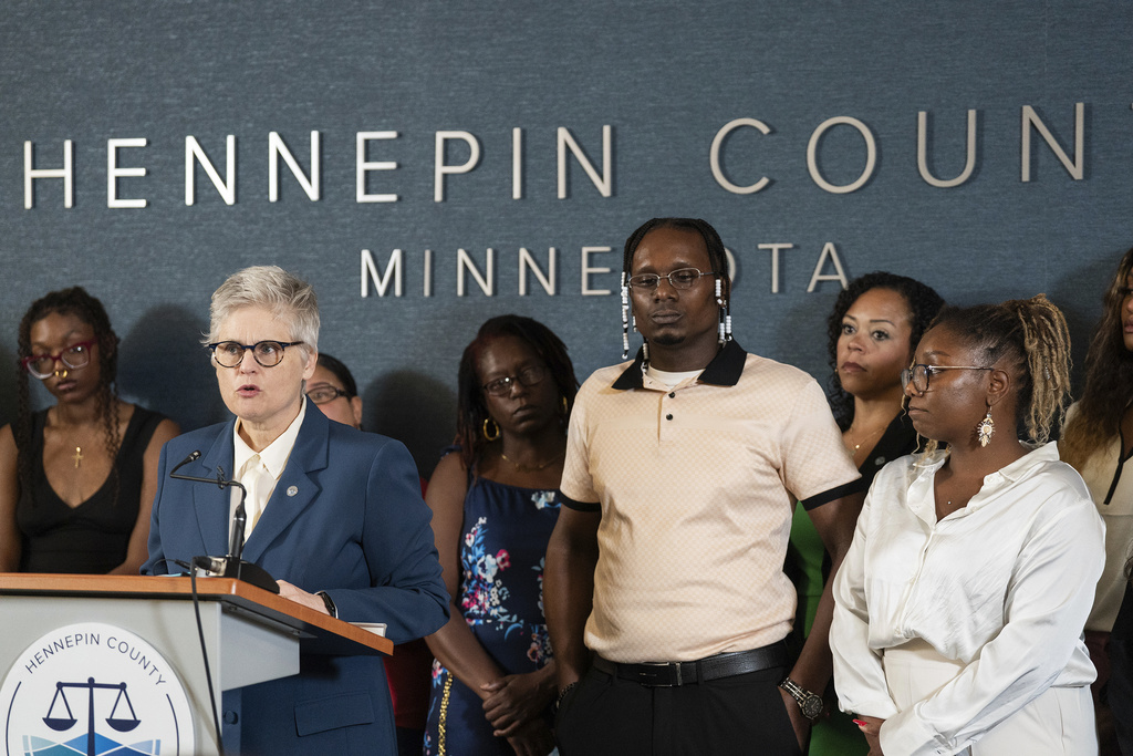 Hennepin County Attorney Mary Moriarty announces that Bryan Hooper Sr. would be freed after 27 years, after another prisoner confessed to the the murder, in Minneapolis, Minn., on Tuesday, Aug. 12, 2025. Bryan's daughter, Briana Hooper, is at right. (Richard Tsong-Taatarii/Star Tribune via AP)