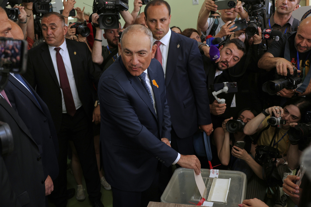 Armenian Prime Minister Nikol Pashinyan, center, casts his ballot at a polling station during the parliamentary election in Yerevan, Armenia, Sunday, June 7, 2026. (AP Photo/Anthony Pizzoferrato)