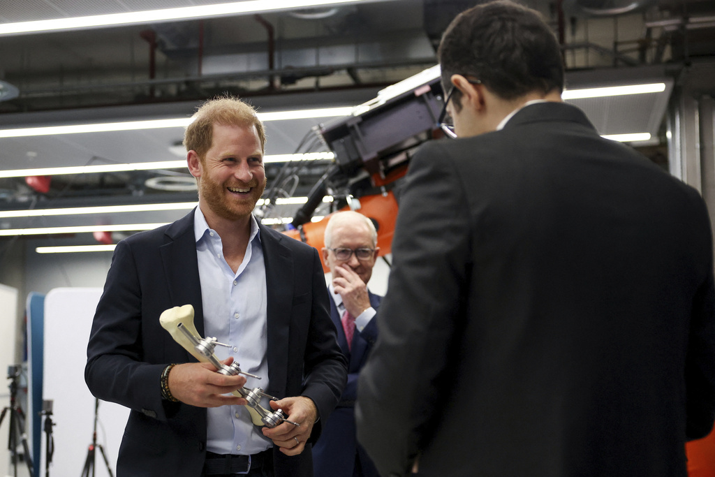 Britain's Prince Harry holds an Imperial External Fixator during a visit to the Centre for Blast Injury Studies at Imperial College London, in London, Wednesday, Sept. 10, 2025. (Suzanne Plunkett, Pool Photo via AP)
