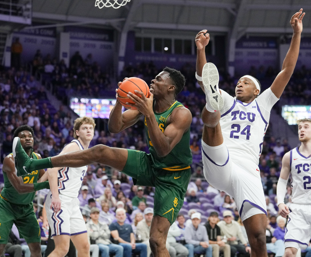 Baylor center James Nnaji (50) grabs a rebound against TCU forward Xavier Edmonds (24) in the first half of an NCAA college basketball game, Saturday, Jan. 3, 2026, in Fort Worth, Texas. (Chris Jones/Waco Tribune-Herald via AP)