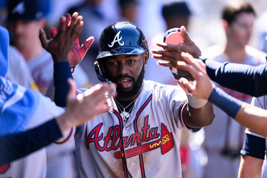 Atlanta Braves' Michael Harris II is greeted by teammates after scoring during the sixth inning of a baseball game against the Los Angeles Angels, Wednesday, April 8, 2026, in Anaheim, Calif. (AP Photo/William Liang)