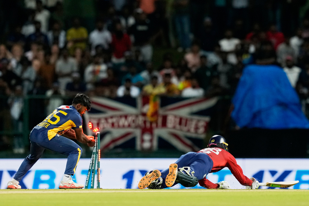 Sri Lanka's Janith Liyanage unsuccessfully attempts a run out as England's Tom Banton successfully completes a run during the second T20 cricket match between England and Sri Lanka in Pallekele, Sri Lanka, Sunday, Feb, 1. 2026. (AP Photo/Eranga Jayawardena)