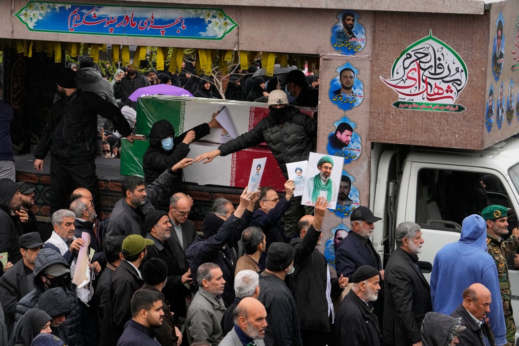 Iranians follow the funeral procession of Iran's intelligence minister Esmail Khatib and, according to Iranian officials, his wife and daughter, in Tehran, Iran, Friday, March 20, 2026. (AP Photo/Vahid Salemi)