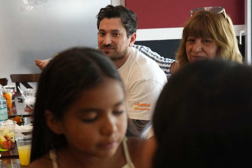 Kyle Adler, a 36-year-old Chilean American who was taken from his family at nine months old and illegally adopted, takes part in a family brunch alongside his birth mother, Ana Maria Navarrete, after traveling from the U.S. to meet her for the first time, in Santiago, Chile, Saturday, Feb. 14, 2026. (AP Photo/Esteban Felix)