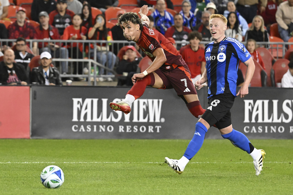 Toronto FC's Theo Corbeanu, left, takes a shot on the CF Montreal goal ahead of CF Montreal's Matty Longstaff during second half MLS soccer action in Toronto on Saturday, August 30, 2025. (Jon Blacker/The Canadian Press via AP)