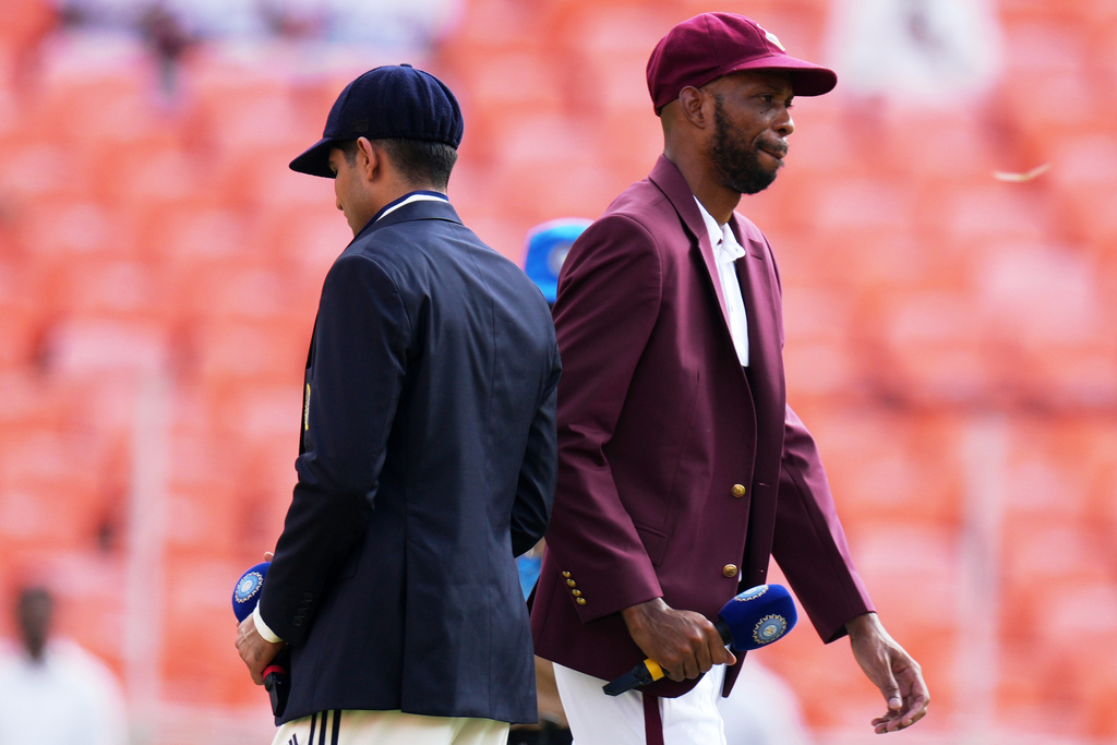 West Indies' captain Roston Chase, right, and India's captain Shubman Gill after toss a coin on the first day of the first Test cricket match between India and West Indies at Narendra Modi Stadium in Ahmedabad, India, Thursday, Oct. 2, 2025. (AP Photo/Ajit Solanki)