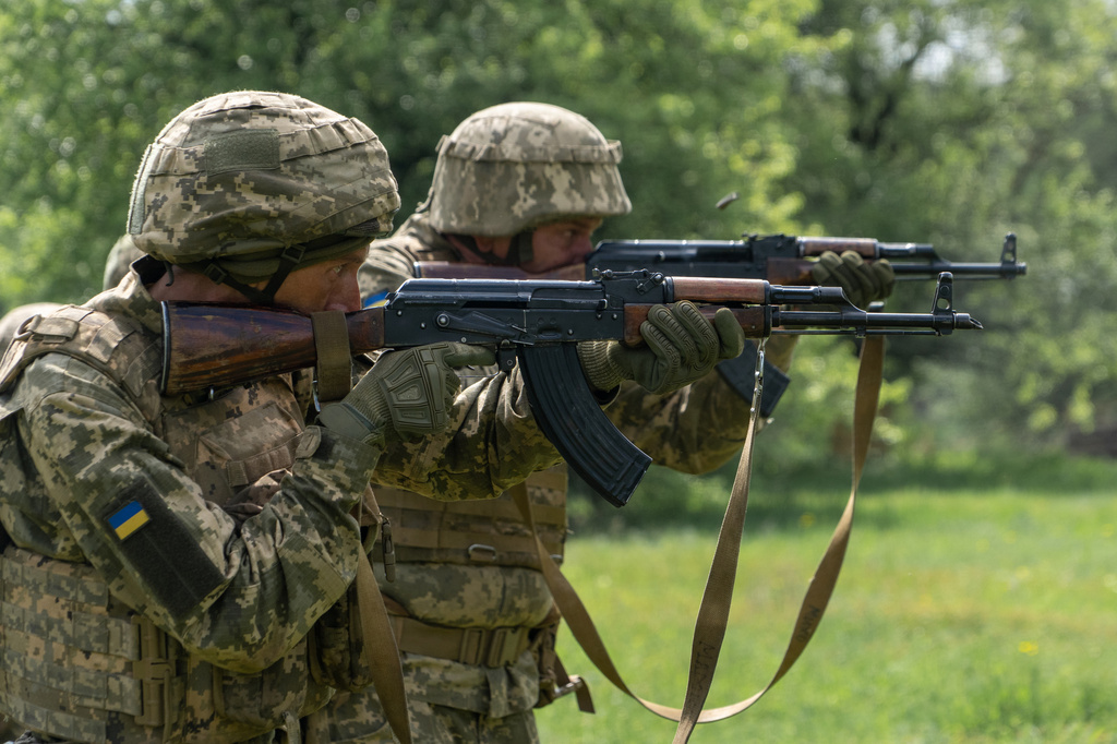 Recruits of Ukraine's 58th Mechanized Brigade practice military skills at a training ground near the frontline in the Kharkiv region, Ukraine, Tuesday, May 12, 2026. (AP Photo/Andrii Marienko)