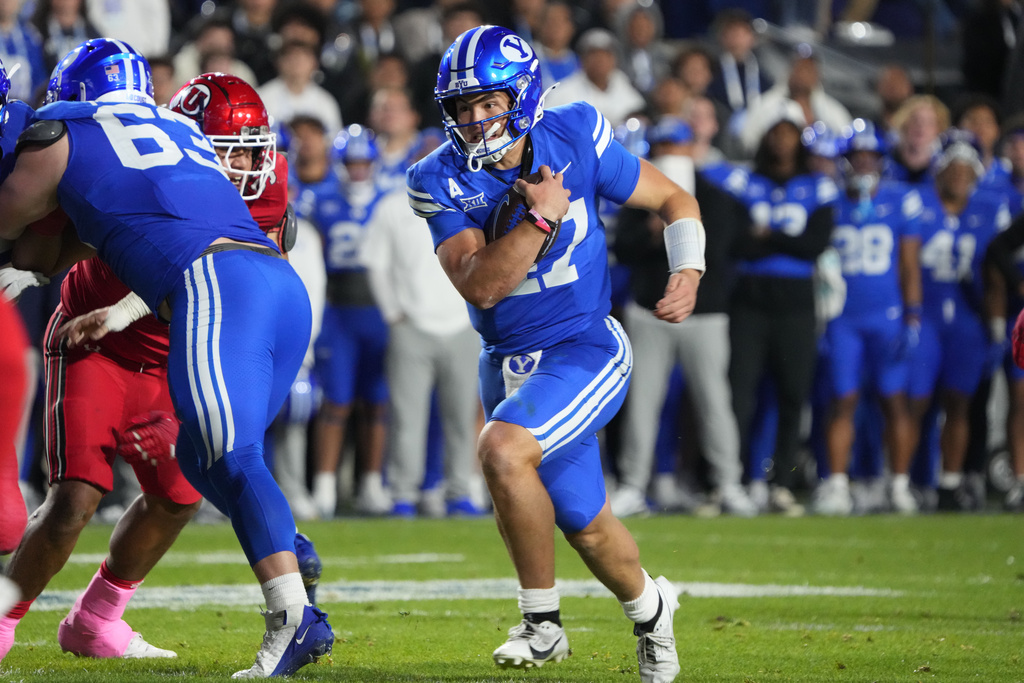 BYU quarterback Bear Bachmeier (47) runs the ball during the first half of an NCAA college football game against Utah, Saturday, Oct. 18, 2025, in Provo, Utah. (AP Photo/George Frey)