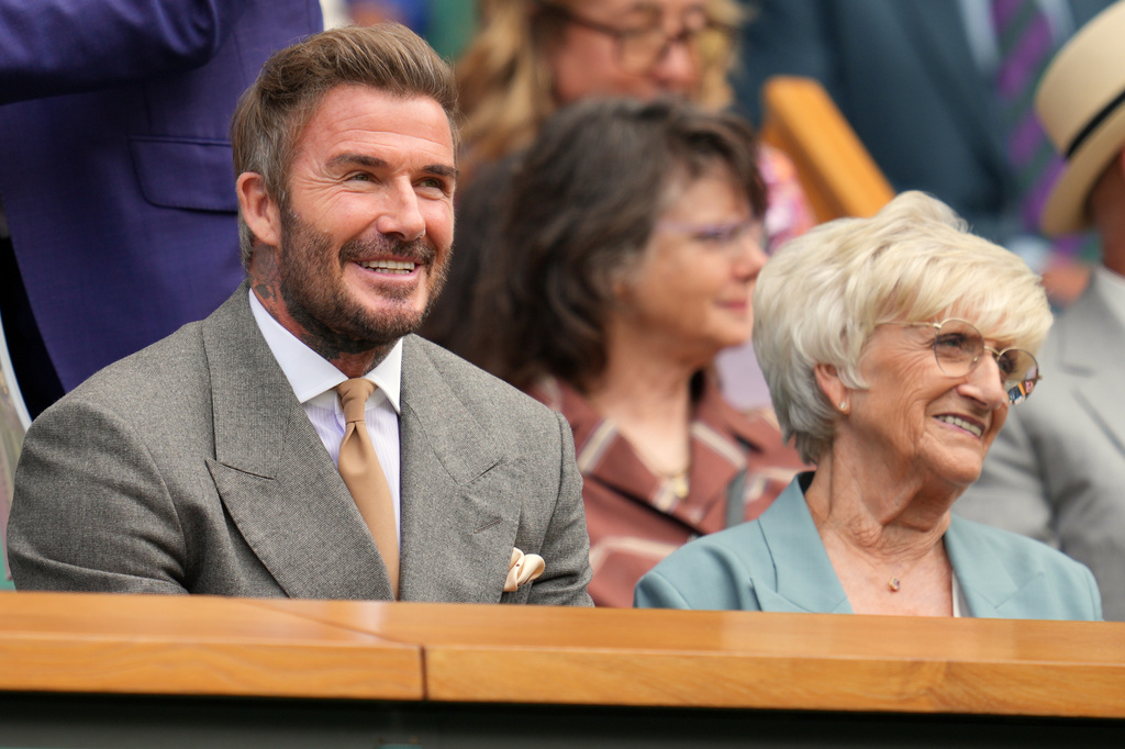 Soccer legend David Beckham sits with his mother Sandra Georgina Beckham in the royal box during the men's singles match between Jannik Sinner of Italy and Miomir Kecmanovic of Serbia at the Wimbledon Tennis Championships in London, Monday, June 29, 2026.(AP Photo/Kin Cheung)