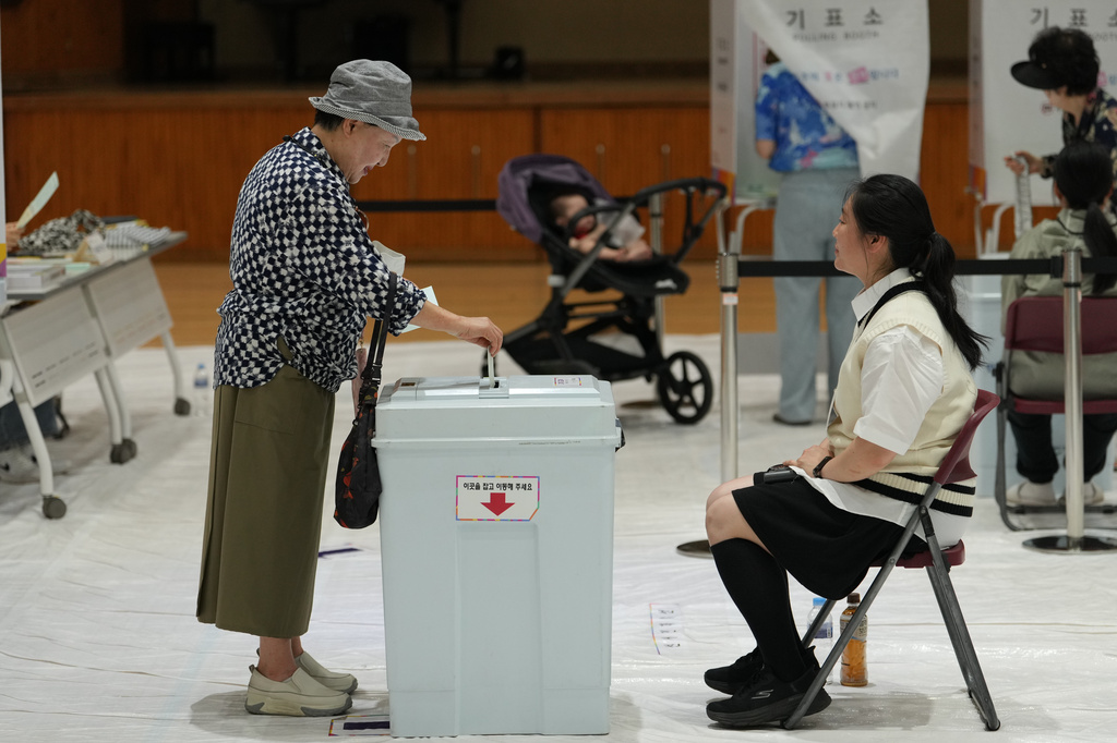 A woman casts her votes for the nationwide simultaneous local elections at a polling station in Seoul, South Korea, Wednesday, June 3, 2026. (AP Photo/Lee Jin-man)