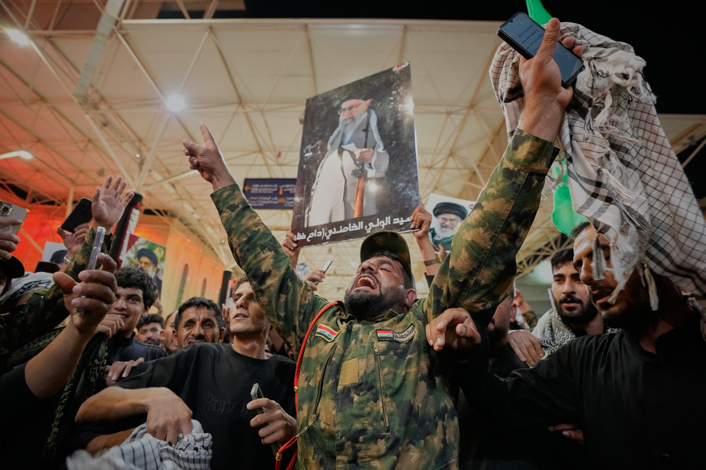An Iraqi Shiite soldier chants on the eve of funeral ceremonies for the late Iranian Supreme Leader Ayatollah Ali Khamenei outside the Imam Ali Shrine in Najaf, Iraq, Tuesday, July 7, 2026. (AP Photo/Hadi Mizban)