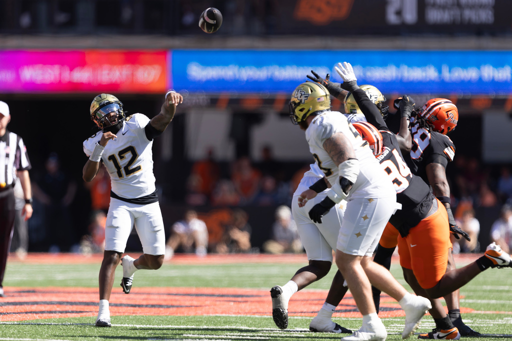 Central Florida quarterback Keyone Jenkins (12) throws a pass in the first half of the NCAA college football game against Oklahoma State in Stillwater, Okla., Saturday, Oct. 10, 2026. (AP Photo/Mitch Alcala)