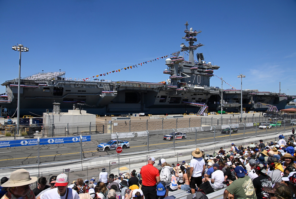 Cars race past the USS Carl Vinson during a NASCAR Cup Series auto race, Sunday, June 21, 2026, in Coronado, Calif. (AP Photo/Denis Poroy)