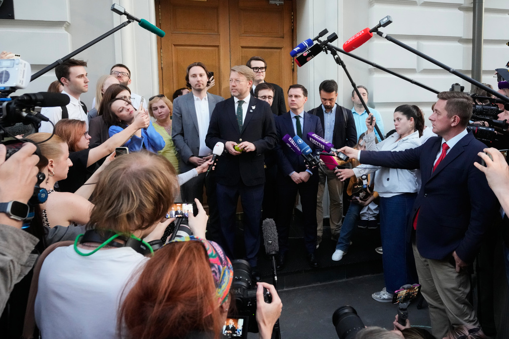 Yabloko party leader Nikolai Rybakov, center, speaks to journalists and supporters after a hearing on a lawsuit to bar the party from the upcoming parliamentary elections, at the Russia's Supreme Court, in Moscow, Monday, Aug. 10, 2026. (AP Photo/Pavel Bednyakov)