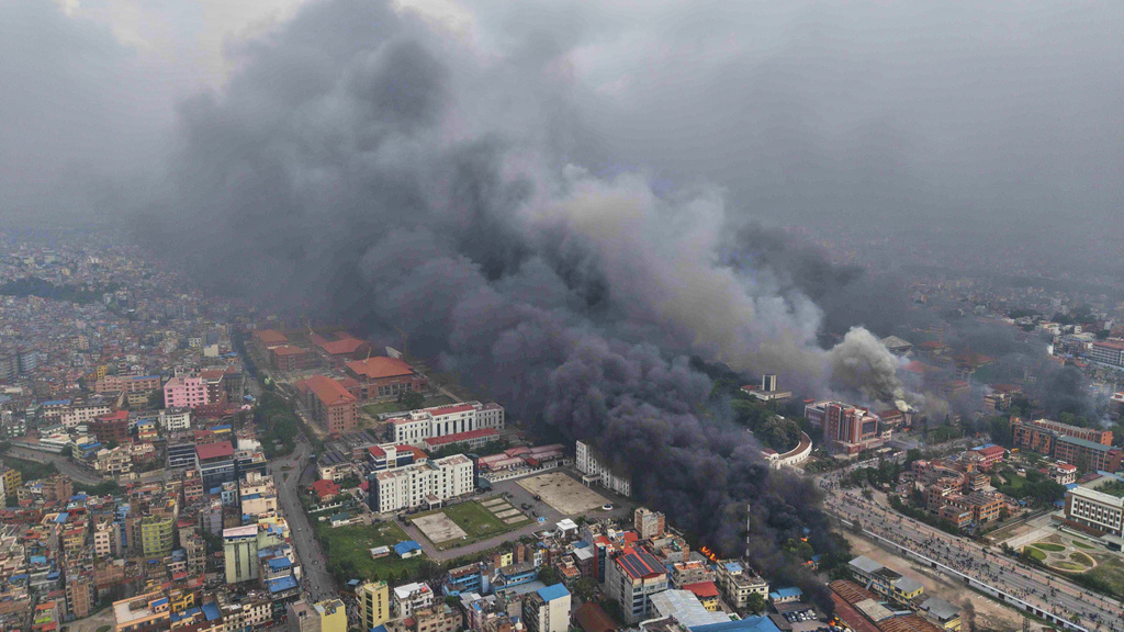 Smoke billows out from various ministries and offices after they were set on fire during a protest against social media ban and corruption in Kathmandu, Nepal, Tuesday, Sept. 9, 2025. (AP Photo/Prakash Timalsina)