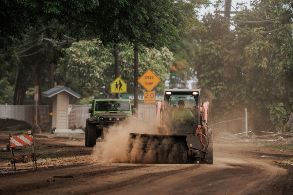 A worker cleans a debris-strewn section of Hawaii Belt Road after Hurricane Lala in Naalehu, Hawaii, Monday, Aug. 17, 2026. (Stephen Lam/San Francisco Chronicle via AP)