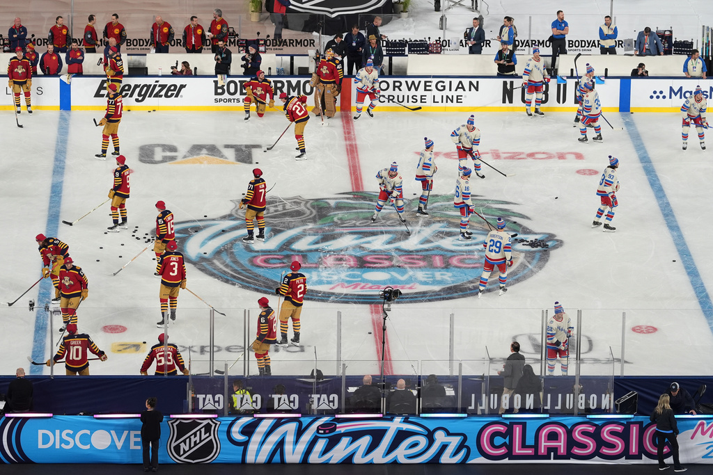 New York Rangers and Florida Panthers players warm up before the NHL Winter Classic outdoor hockey game, Friday, Jan. 2, 2026, in Miami. (AP Photo/Rebecca Blackwell)