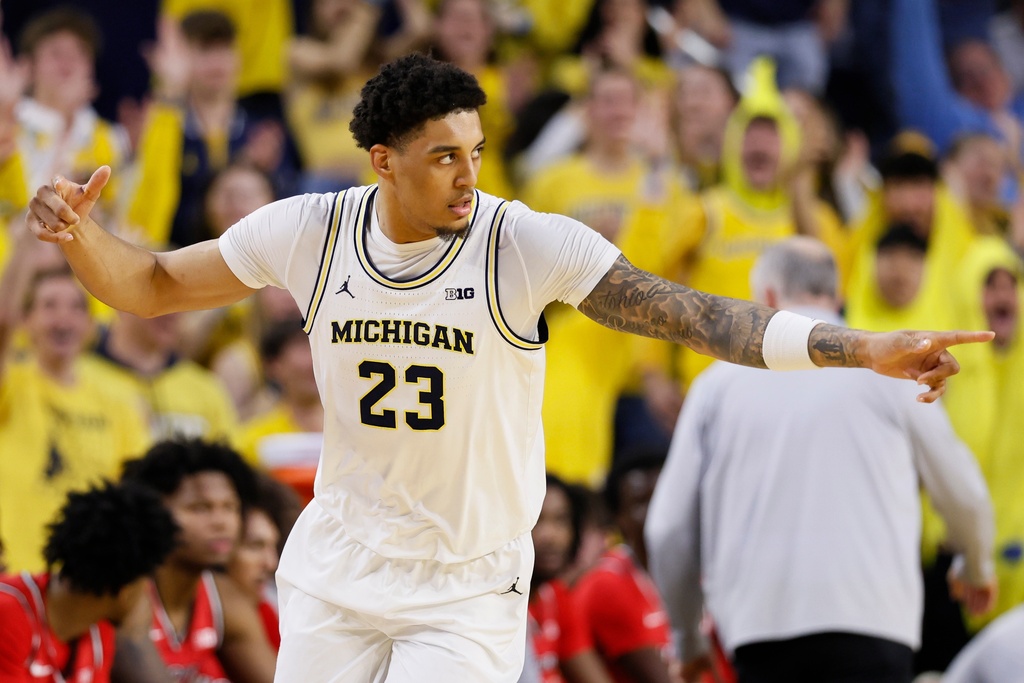 Michigan forward Yaxel Lendeborg (23) celebrates after scoring a 3-point basket against Rutgers during the first half of an NCAA college basketball game Saturday, Dec. 6, 2025, in Ann Arbor, Mich. (AP Photo/Duane Burleson)