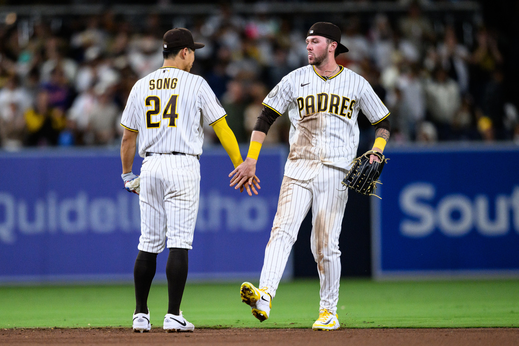 San Diego Padres center fielder Jackson Merrill, right, is greeted by San Diego Padres second baseman Sung-Mun Song (24) after defeating the Athletics, Saturday, May 23, 2026, in San Diego. (AP Photo/William Liang)